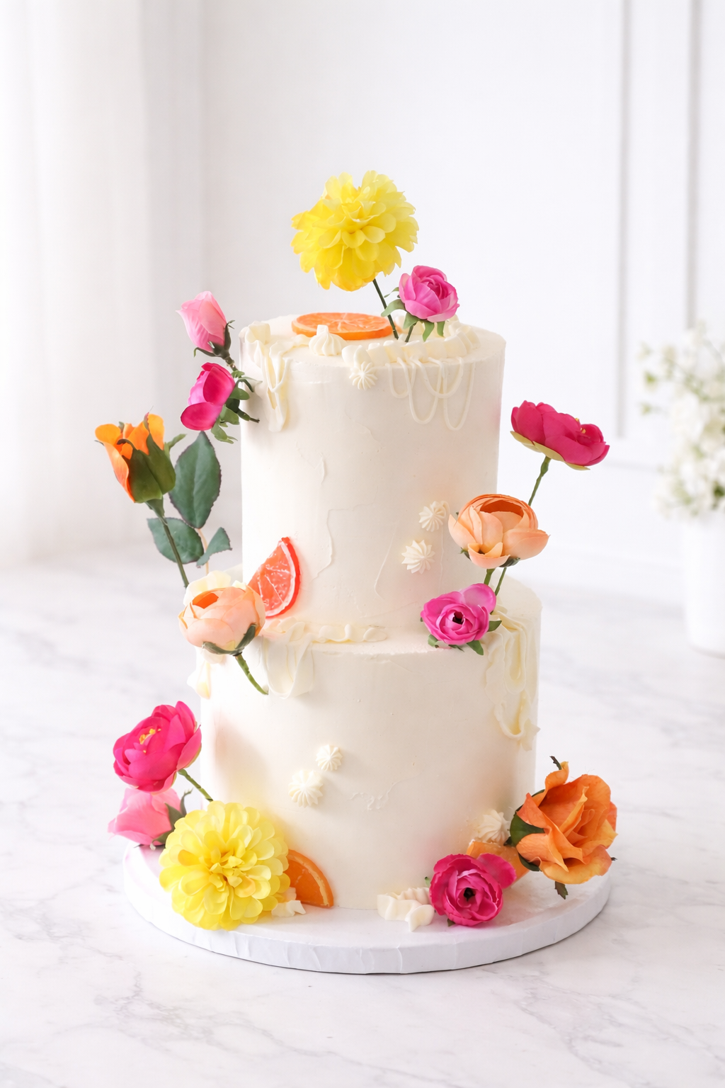 Two-tiered wedding cake, bridal shower cake, baby shower, birthday white cake decorated with colorful flowers on a white background